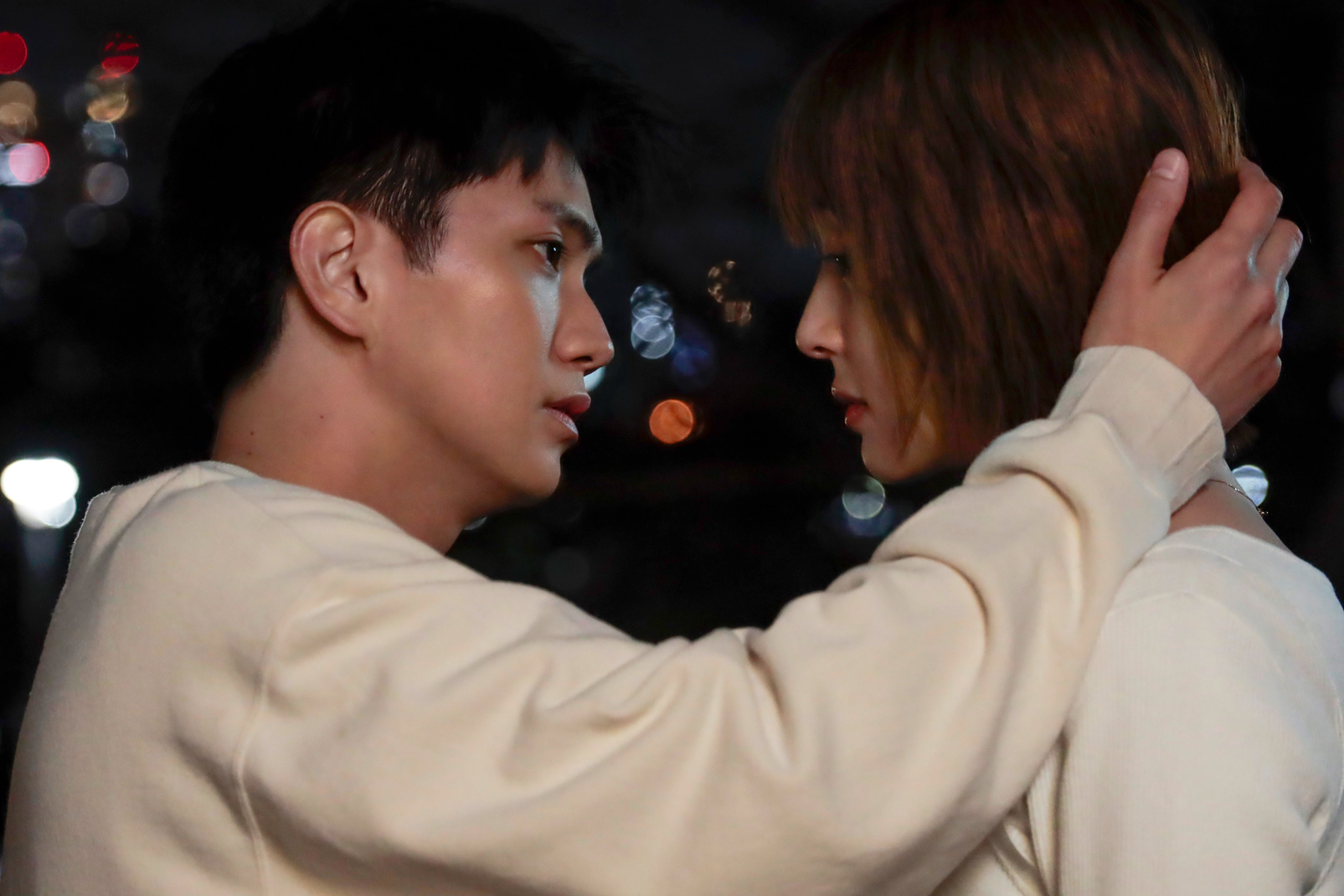 A close-up shot of two characters in a dramatic moment from the TV drama 'Musashino Rondo', with one character gently holding the other by the head, emphasizing emotional intensity and connection.